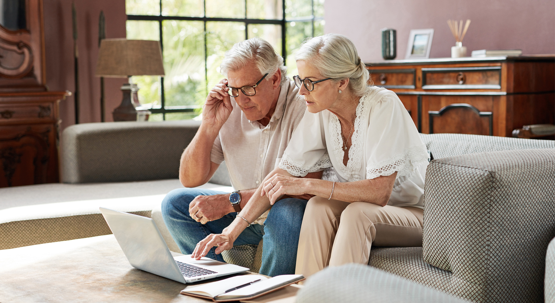 image showing an old couple looking on a laptop