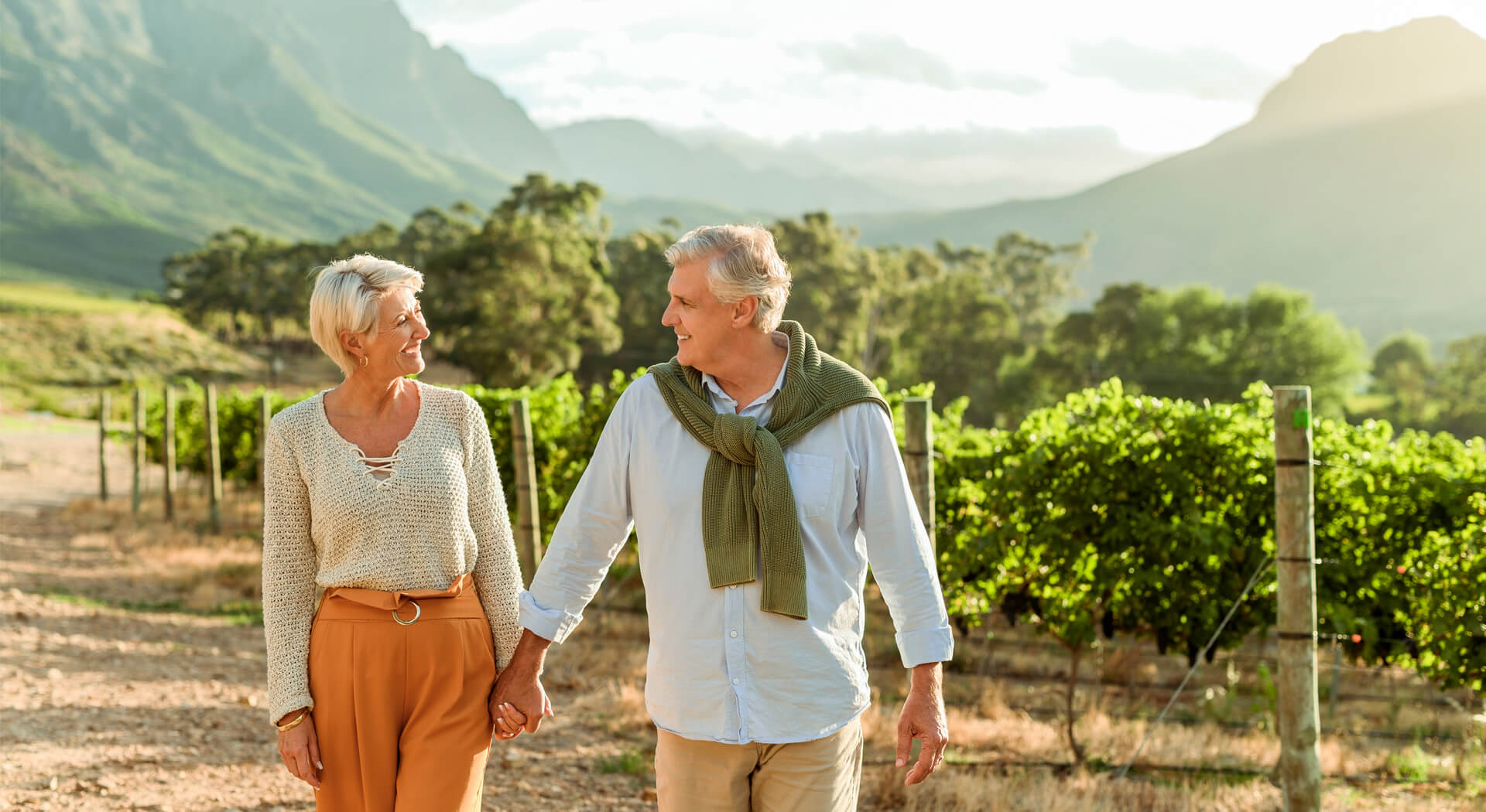 image showing a senior couple walking on a wine farm